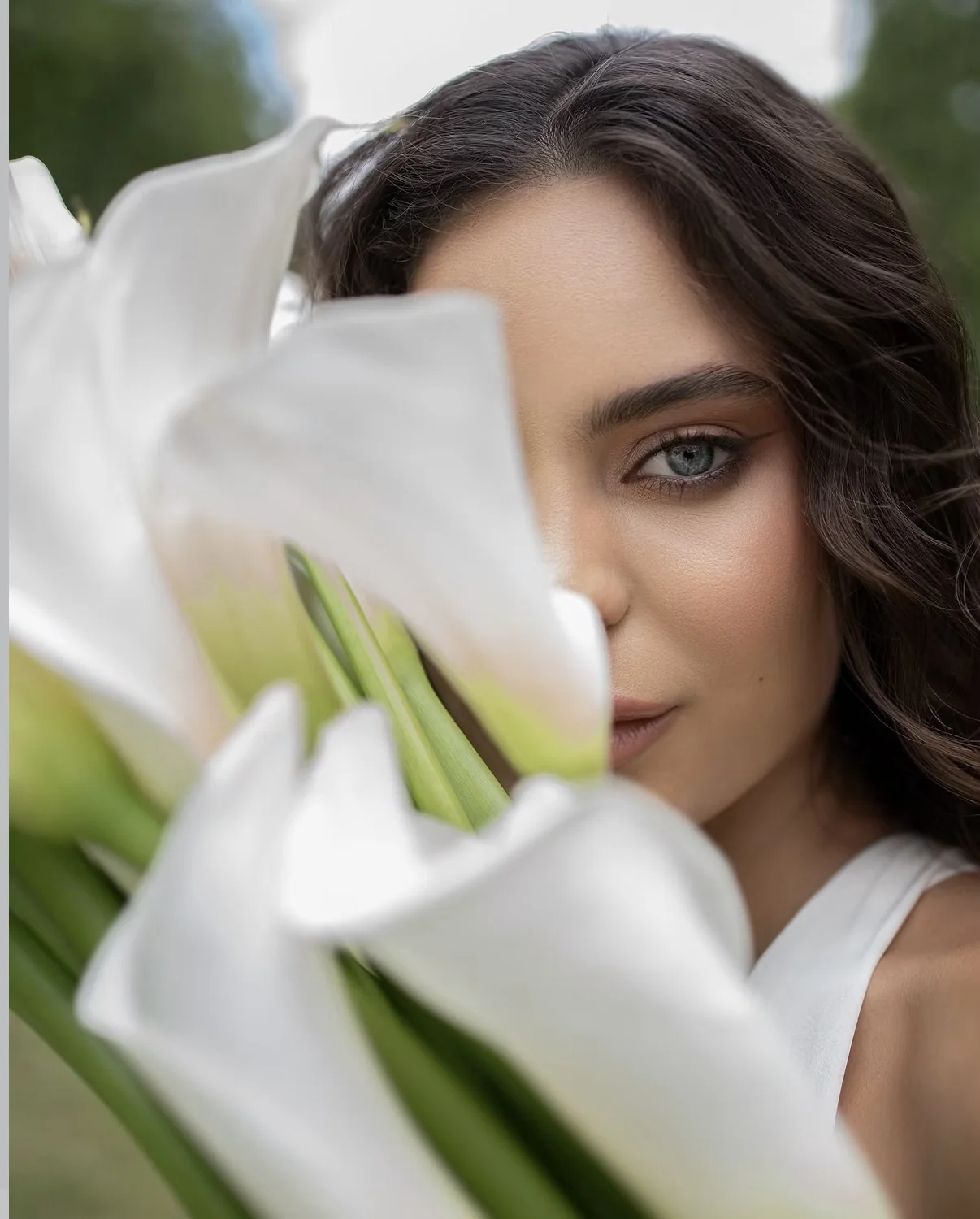 Beauty portrait framed by white calla lilies