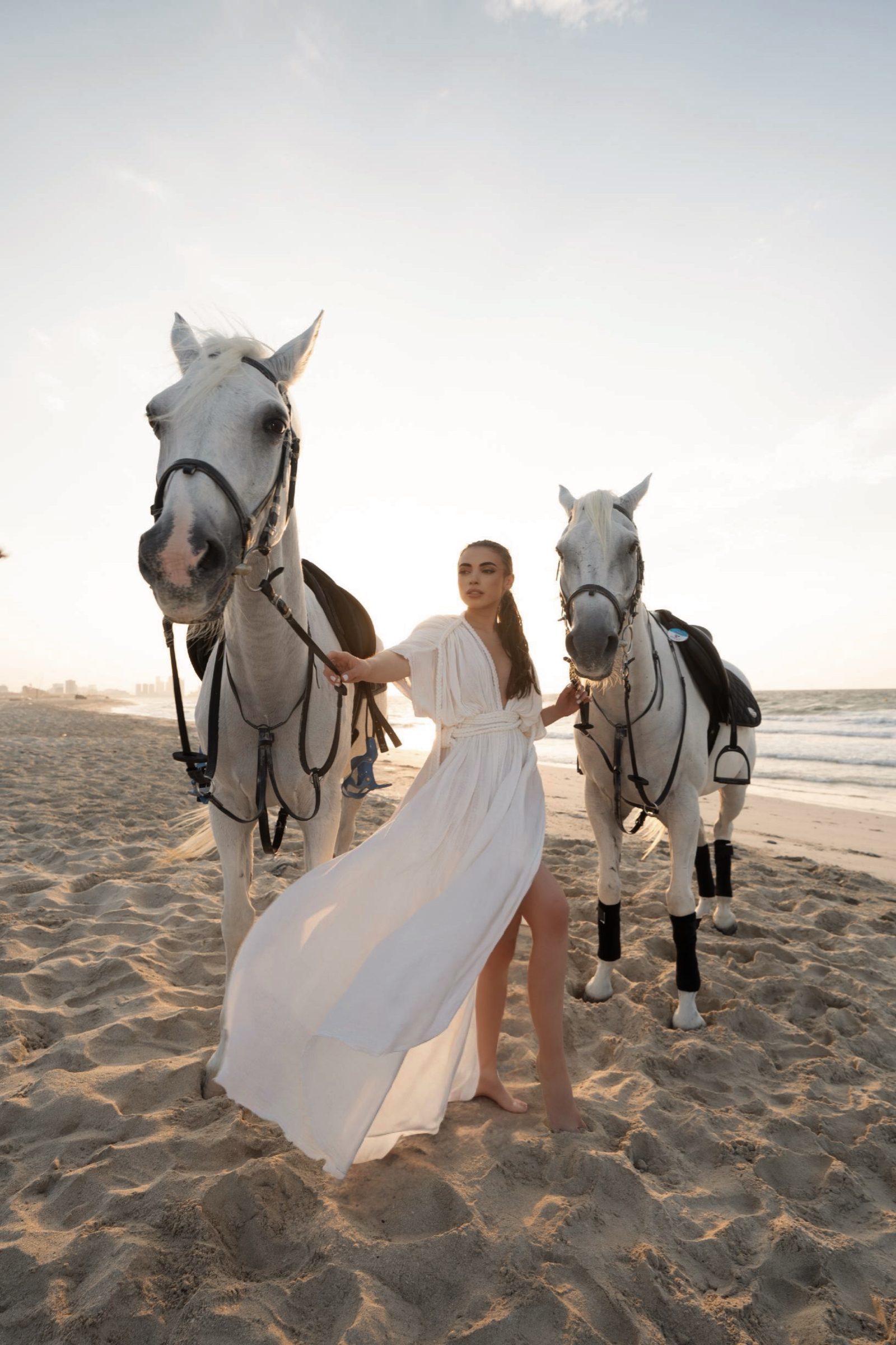 Editorial horses on beach — resort lifestyle content